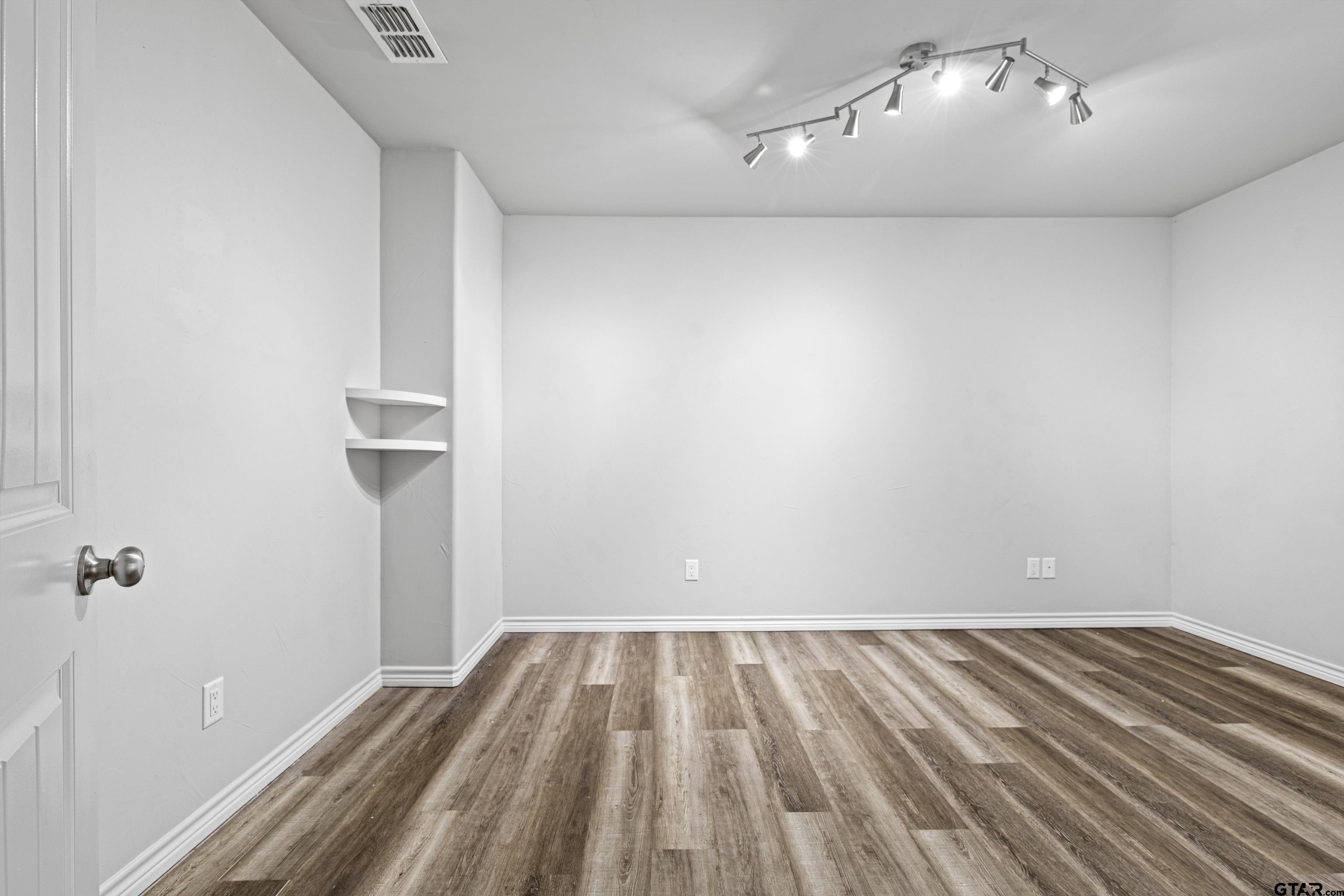 302 Collins Avenue Longview, TX 75605 - Photo 23 of 36 a view of room with wooden floor