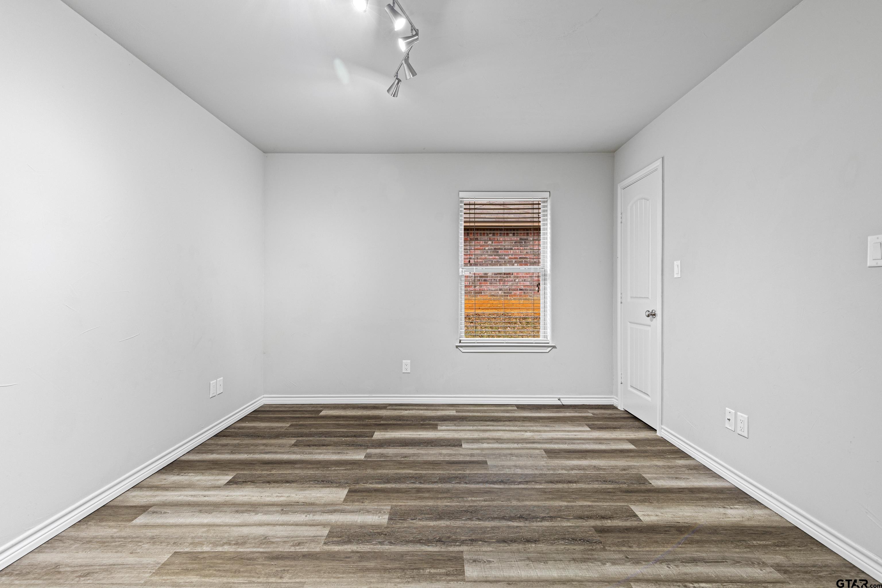 302 Collins Avenue Longview, TX 75605 - Photo 33 of 36 a view of empty room with window and wooden floor