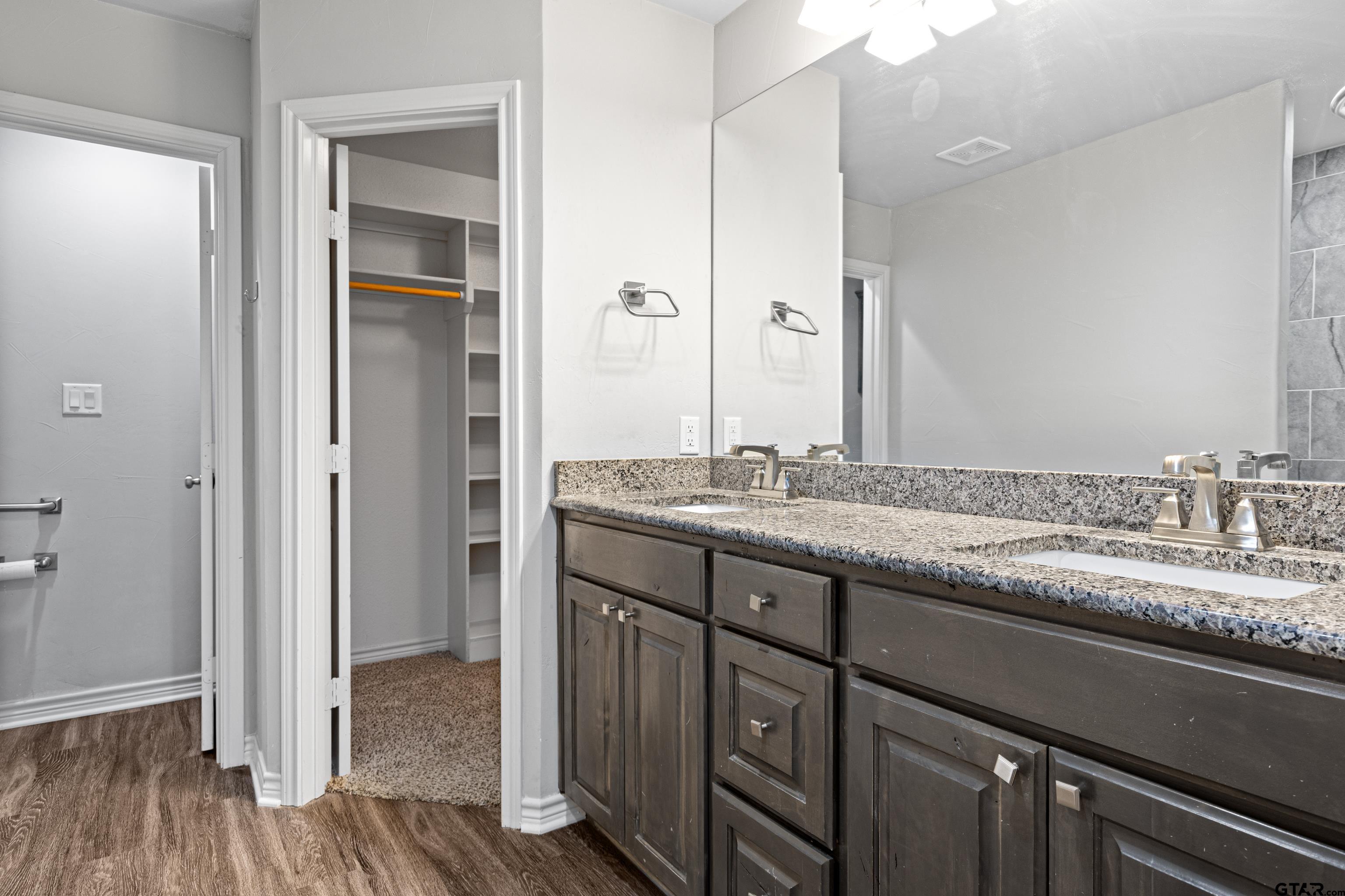 302 Collins Avenue Longview, TX 75605 - Photo 8 of 36 a bathroom with a granite countertop sink and a mirror