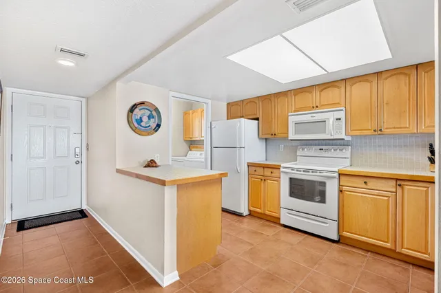 a kitchen with stainless steel appliances a stove sink and white cabinets