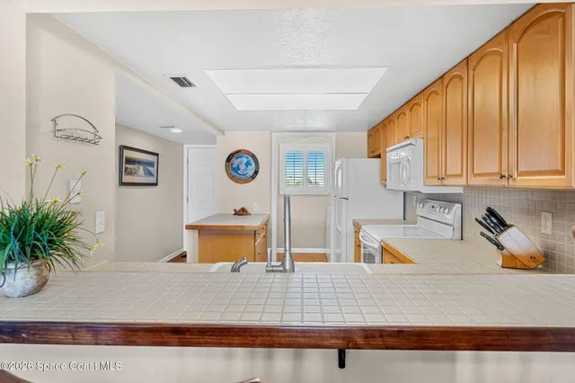 a view of a living room and kitchen