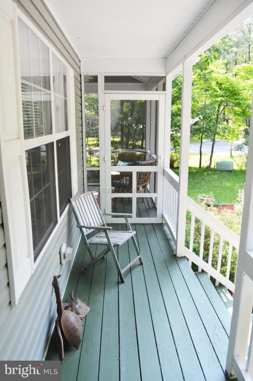 66 Sandyhook Road Ocean Pines, MD 21811 - Photo 2 of 18 a balcony with wooden floor and furniture