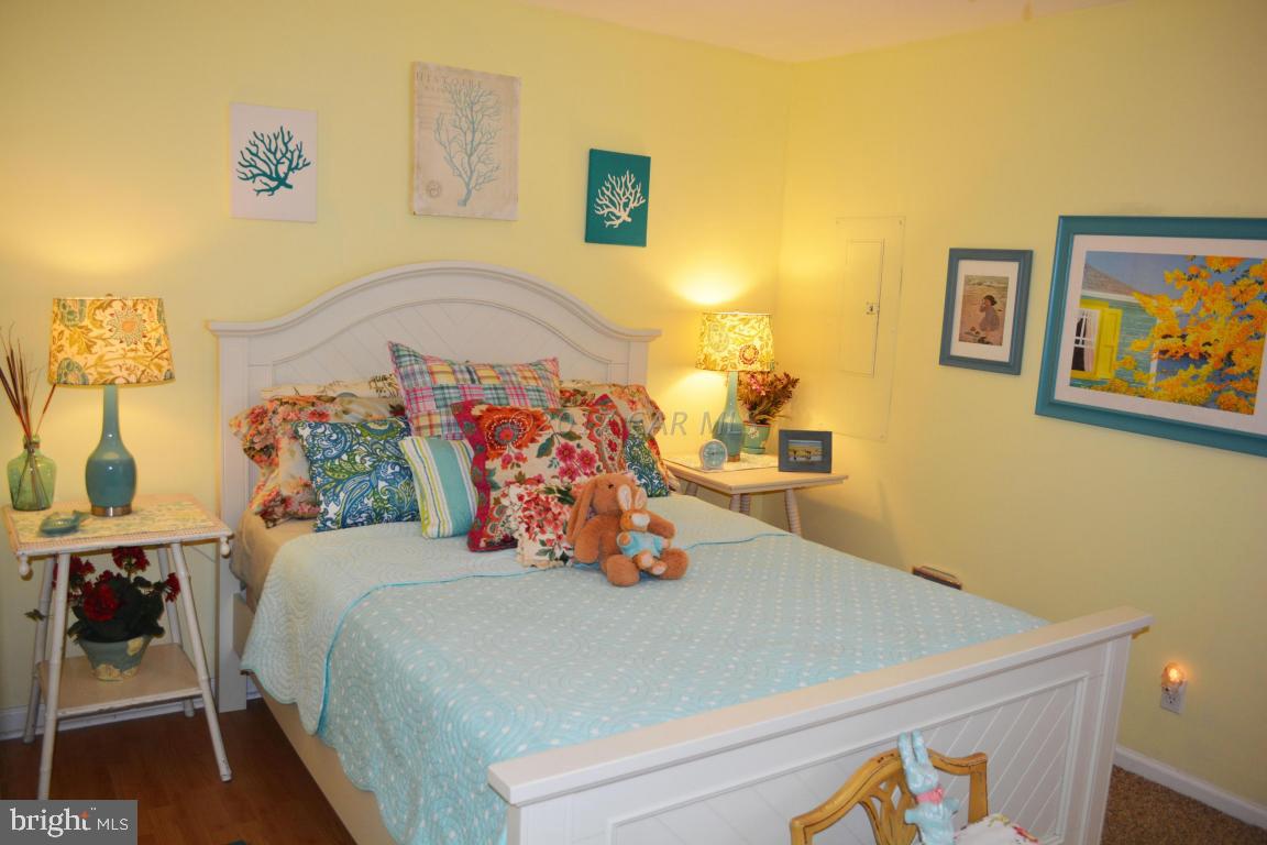 66 Sandyhook Road Ocean Pines, MD 21811 - Photo 11 of 18 a bedroom with a bed and wooden floor