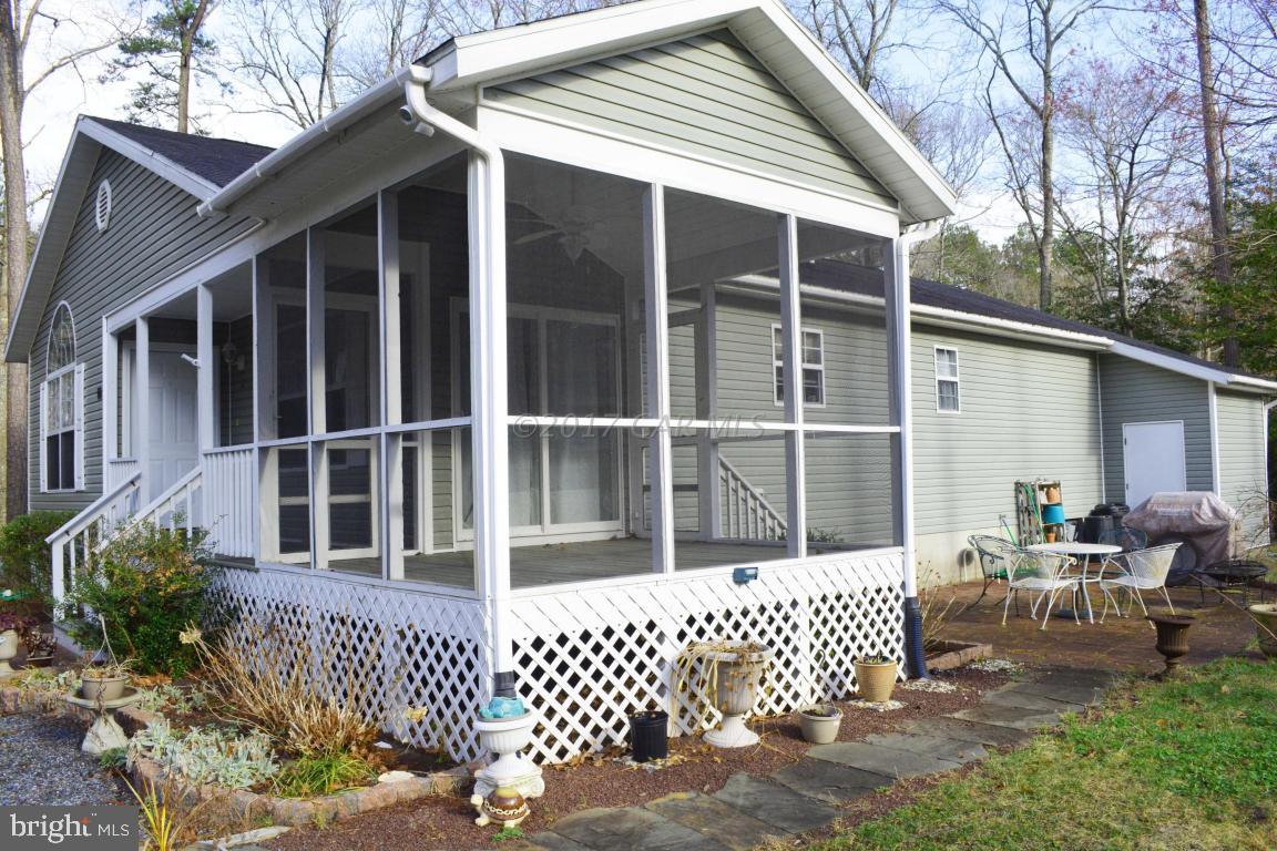 66 Sandyhook Road Ocean Pines, MD 21811 - Photo 17 of 18 a view of a house with a large window and wooden fence