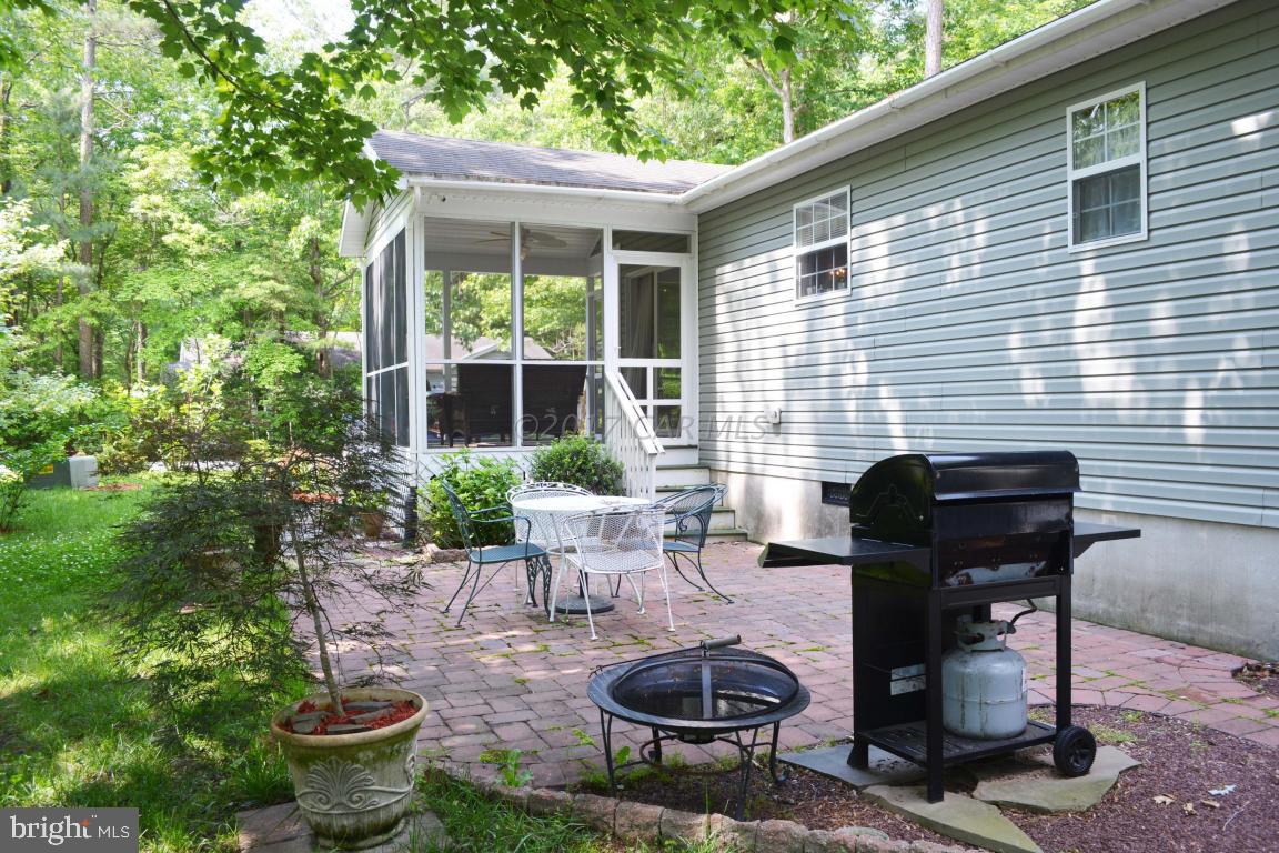 66 Sandyhook Road Ocean Pines, MD 21811 - Photo 18 of 18 a view of a patio with chairs and a table