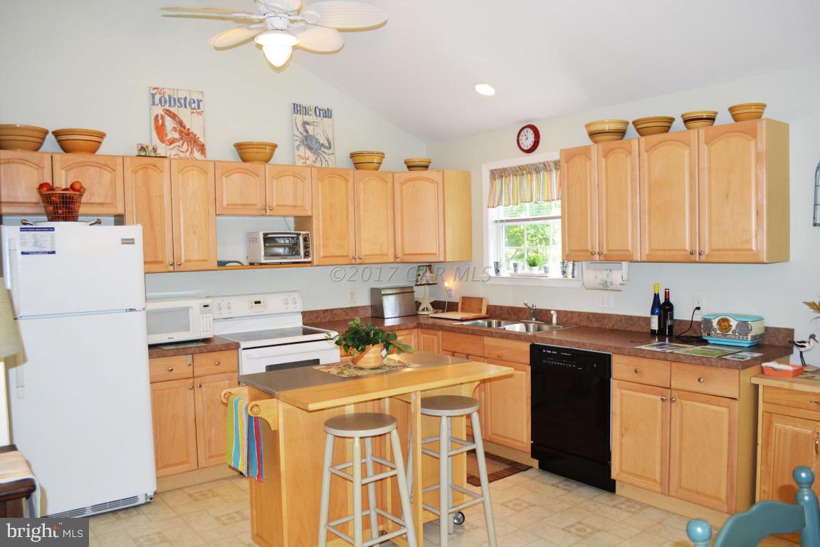66 Sandyhook Road Ocean Pines, MD 21811 - Photo 3 of 18 a kitchen with a sink a stove a refrigerator and cabinets