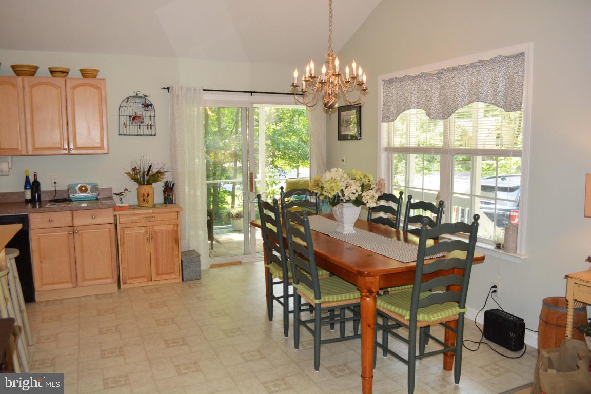 66 Sandyhook Road Ocean Pines, MD 21811 - Photo 4 of 18 a dining room filled chandelier and wooden floor