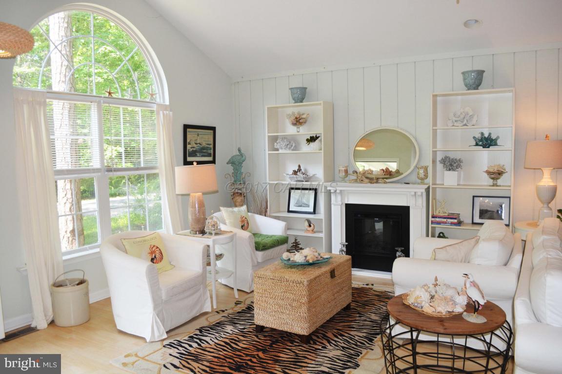 66 Sandyhook Road Ocean Pines, MD 21811 - Photo 5 of 18 a living room with furniture a fireplace and a large window