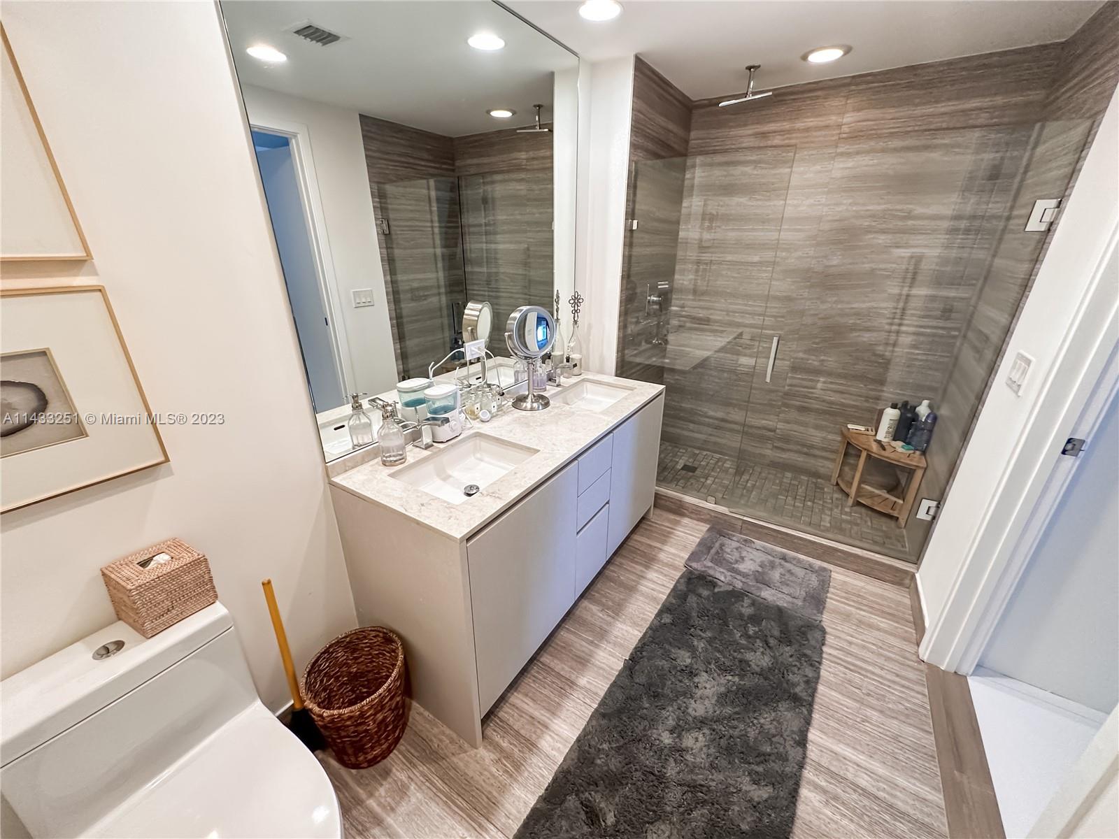 1010 Brickell Avenue, Unit 2505 Miami, FL 33131 - Photo 15 of 38 a bathroom with a sink a toilet and shower