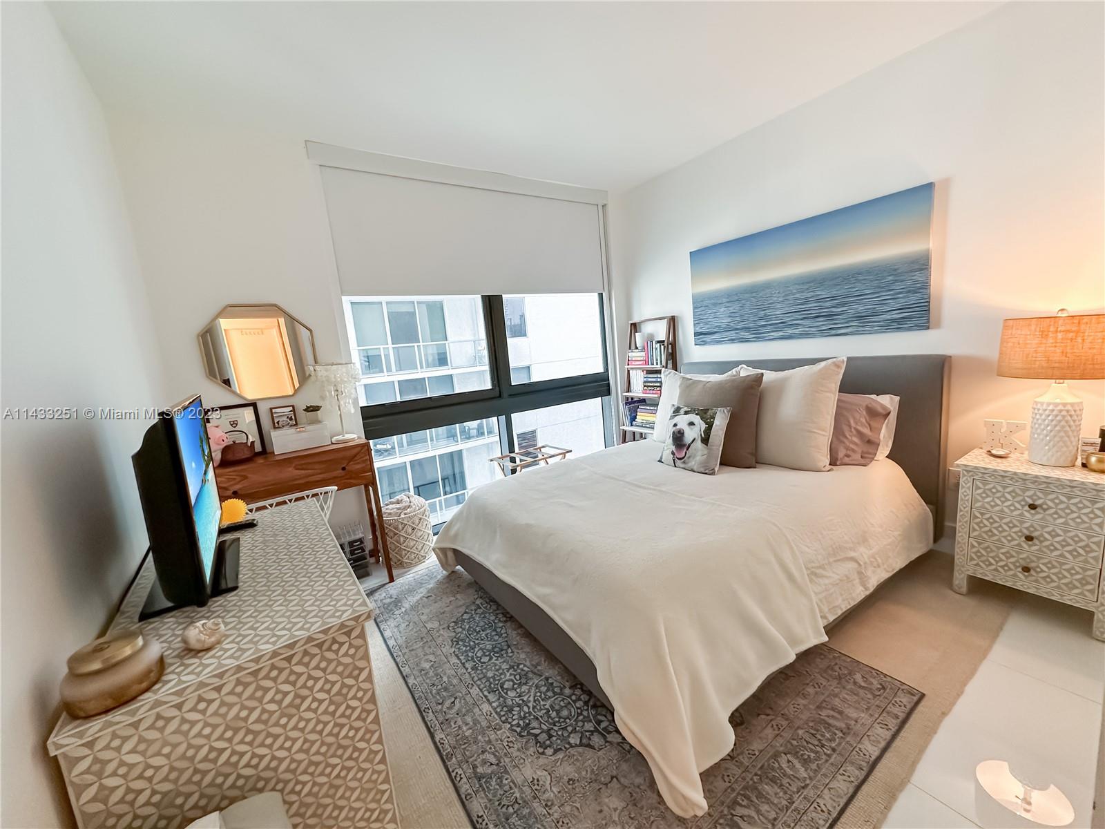 1010 Brickell Avenue, Unit 2505 Miami, FL 33131 - Photo 16 of 38 a bedroom with a bed a couch and dresser