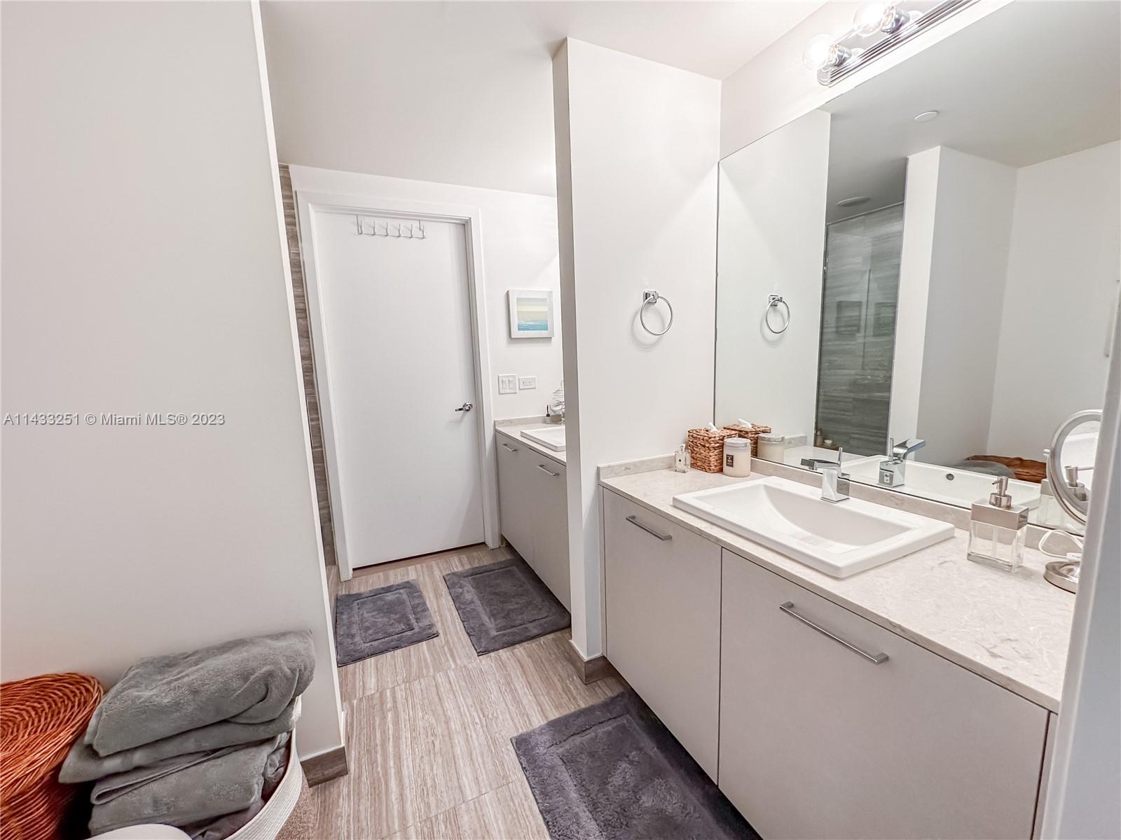 1010 Brickell Avenue, Unit 2505 Miami, FL 33131 - Photo 17 of 38 a bathroom with a sink a mirror and a toilet