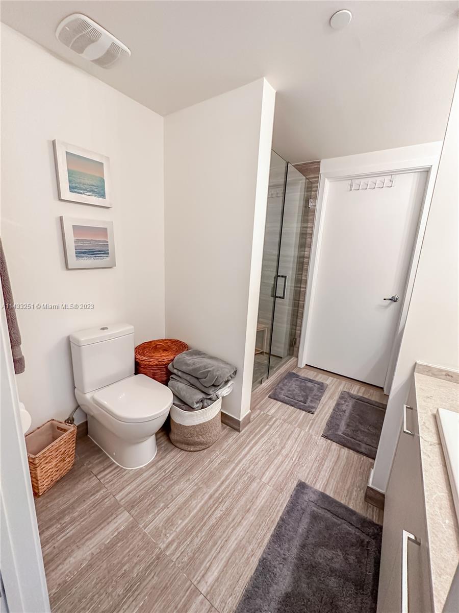 1010 Brickell Avenue, Unit 2505 Miami, FL 33131 - Photo 18 of 38 a bathroom with a toilet and a mirror