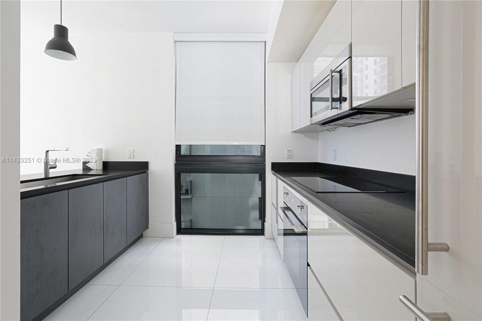1010 Brickell Avenue, Unit 2505 Miami, FL 33131 - Photo 26 of 38 a kitchen with stainless steel appliances a refrigerator and a stove