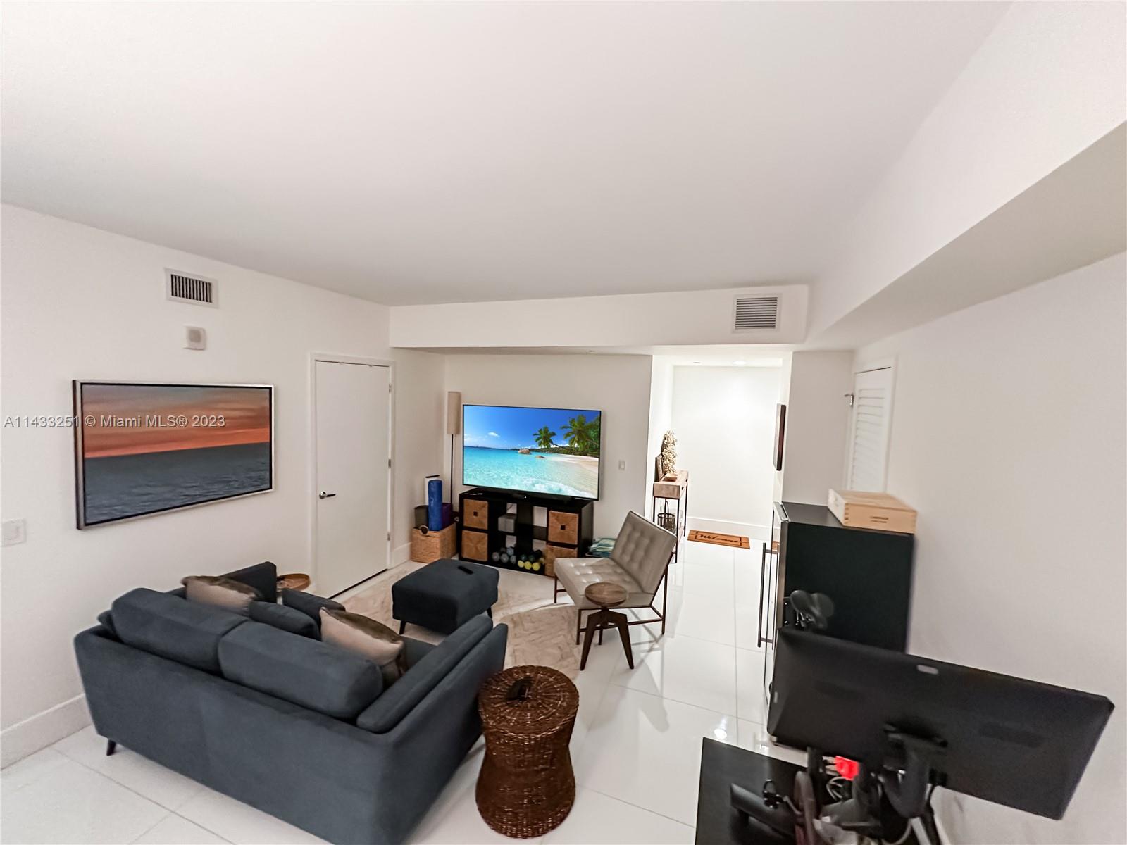 1010 Brickell Avenue, Unit 2505 Miami, FL 33131 - Photo 3 of 38 a living room with furniture and a flat screen tv