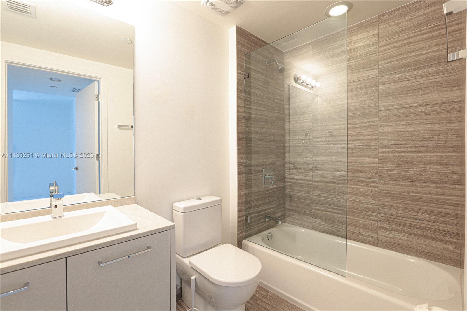 1010 Brickell Avenue, Unit 2505 Miami, FL 33131 - Photo 38 of 38 a bathroom with a sink a toilet and shower