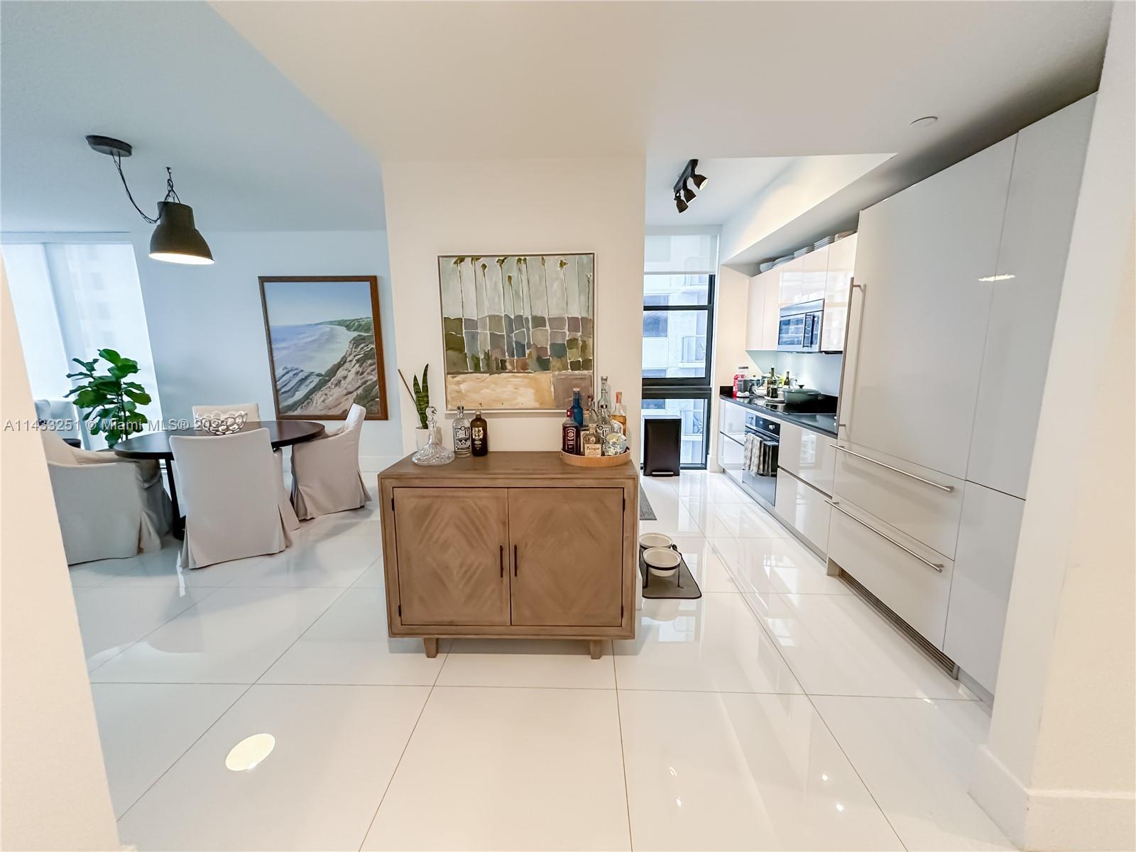 1010 Brickell Avenue, Unit 2505 Miami, FL 33131 - Photo 4 of 38 a living room with furniture and a large window