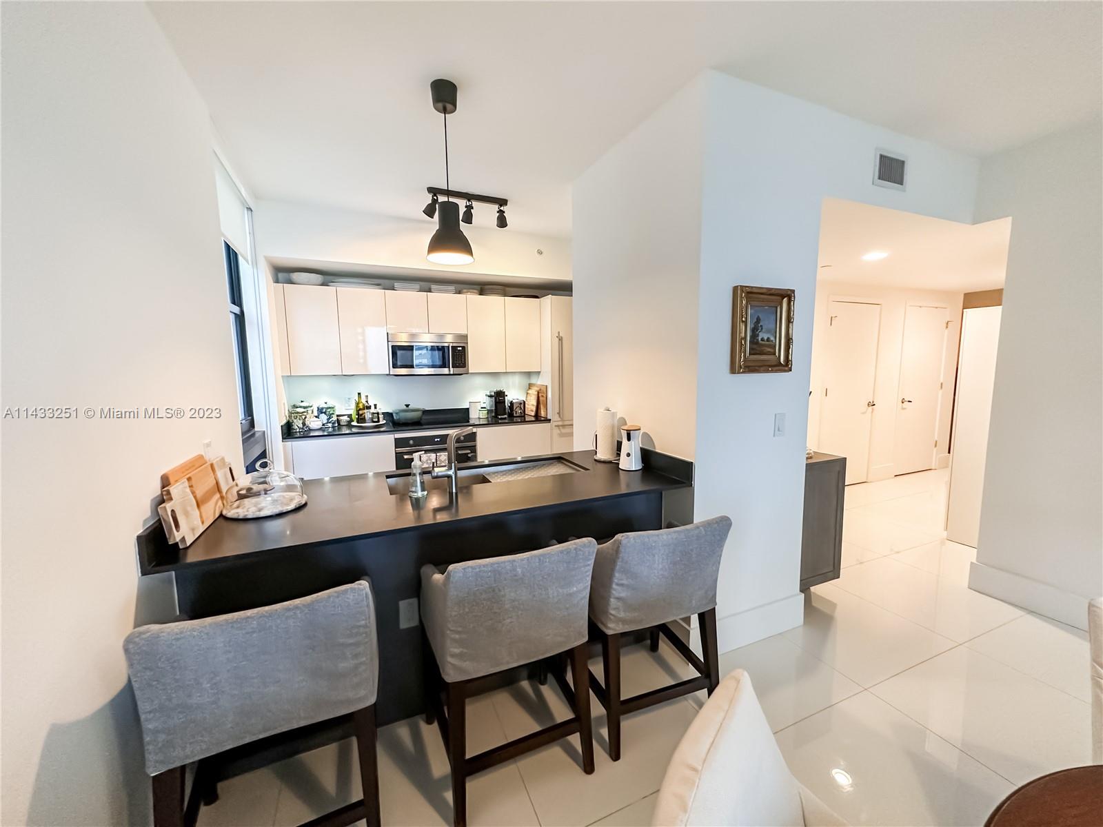 1010 Brickell Avenue, Unit 2505 Miami, FL 33131 - Photo 9 of 38 a dining room with furniture and window