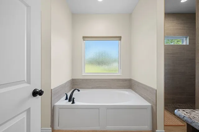 a bedroom with furniture and a window