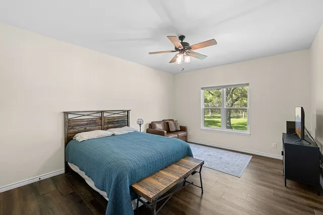 a bathroom with a granite countertop sink a mirror and shower