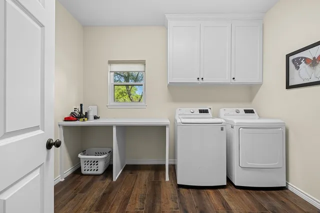 aerial view of a house with a yard and lake view