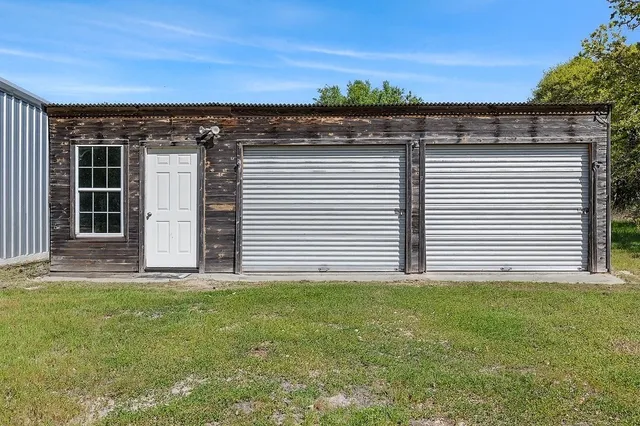 an aerial view of a house with a yard and large trees