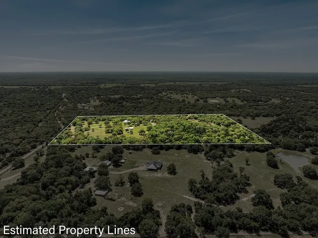 a view of outdoor space with green field and trees all around
