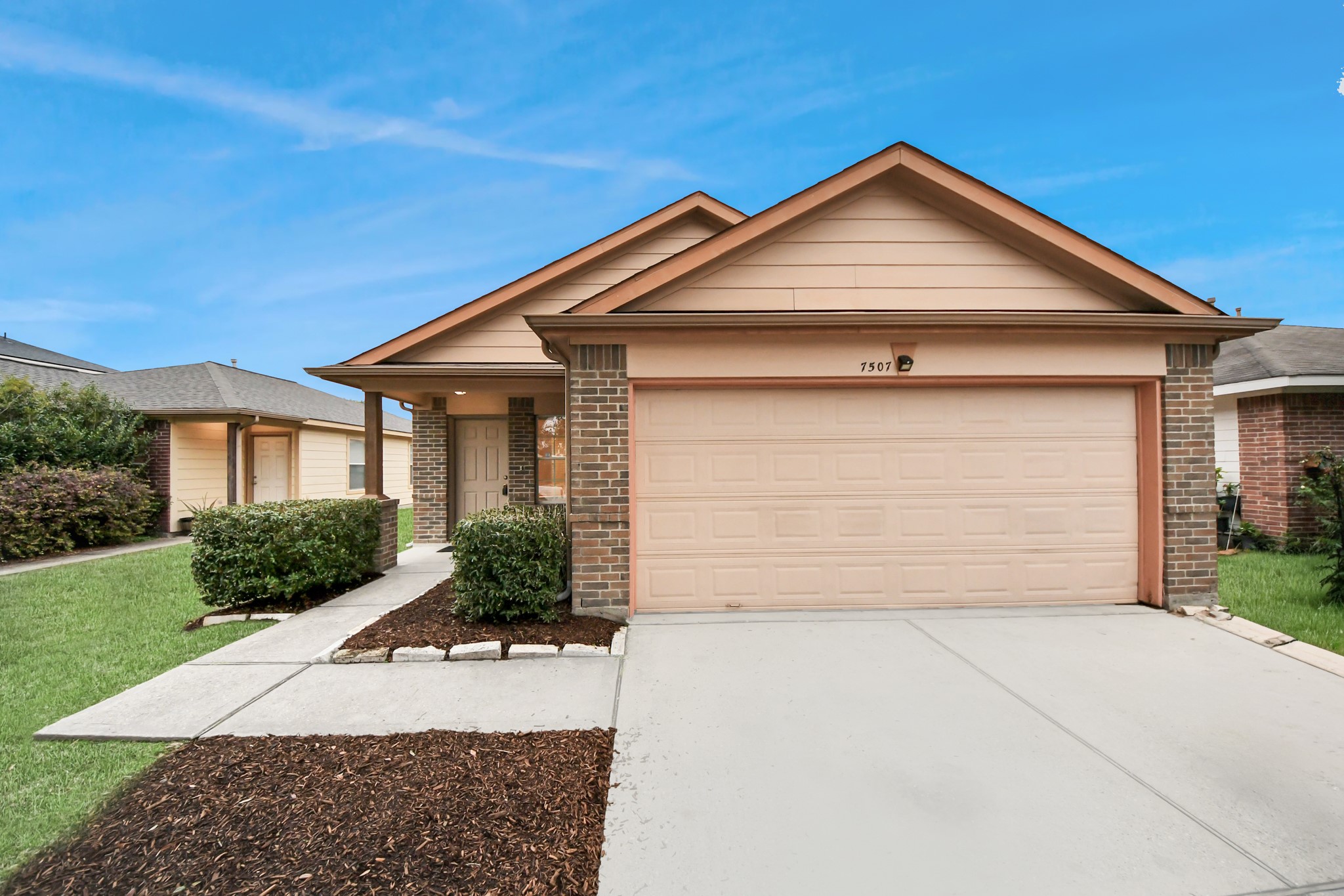 a front view of a house with a yard and garage