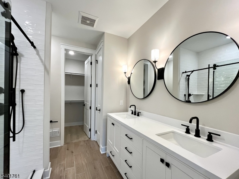 104 Myrtle Road Warren, NJ 07059 - Photo 13 of 26 a bathroom with a double vanity sink double vanity and a mirror