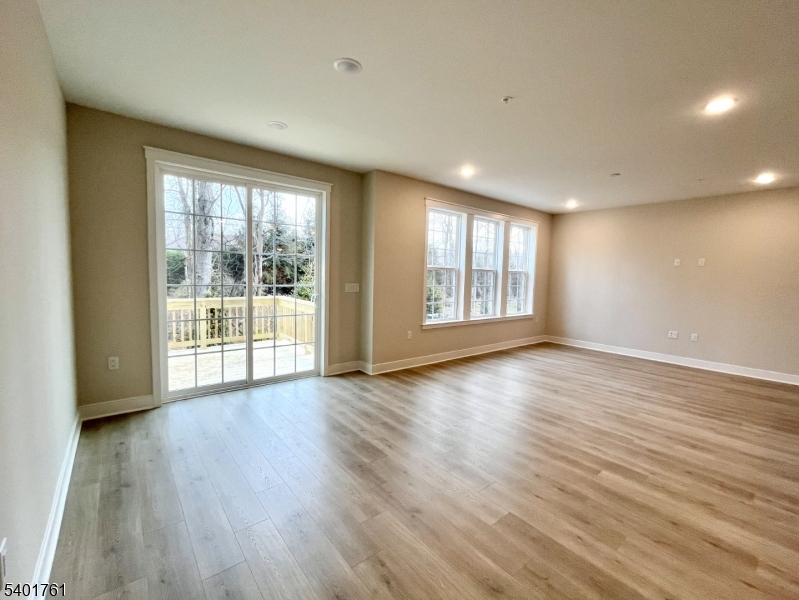 104 Myrtle Road Warren, NJ 07059 - Photo 8 of 26 a view of an empty room with wooden floor and a window