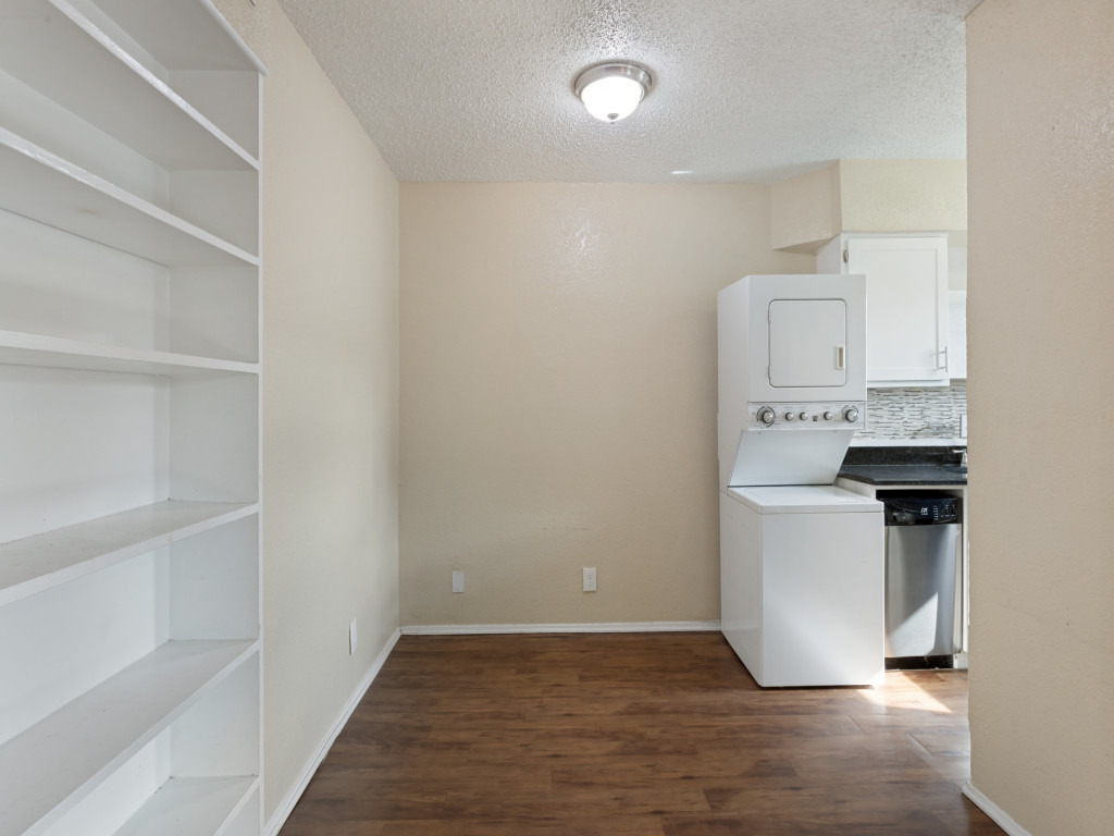 2401 Manor Road, Unit 218 Austin, TX 78722 - Photo 22 of 27 Functional kitchen and laundry area with built-in shelving, ready for streamlined living.