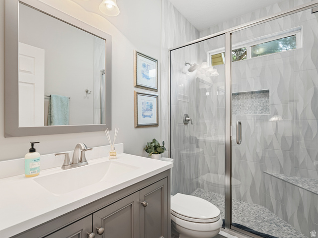 11881 Cottage View Lane Draper, UT 84020 - Photo 12 of 29 Bathroom featuring a glass-enclosed shower with textured wall tile and a mosaic-tiled niche