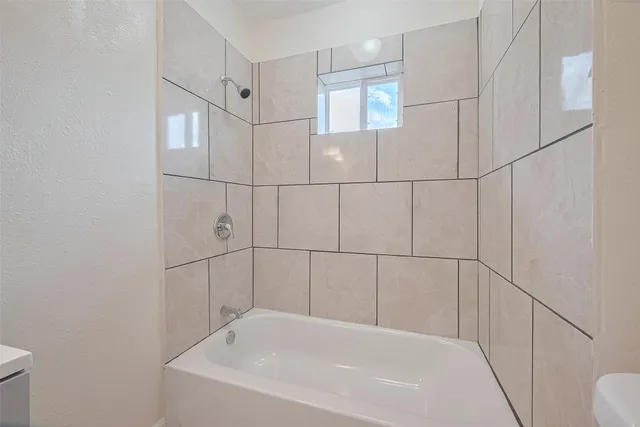 a bathroom with a bathtub and shower