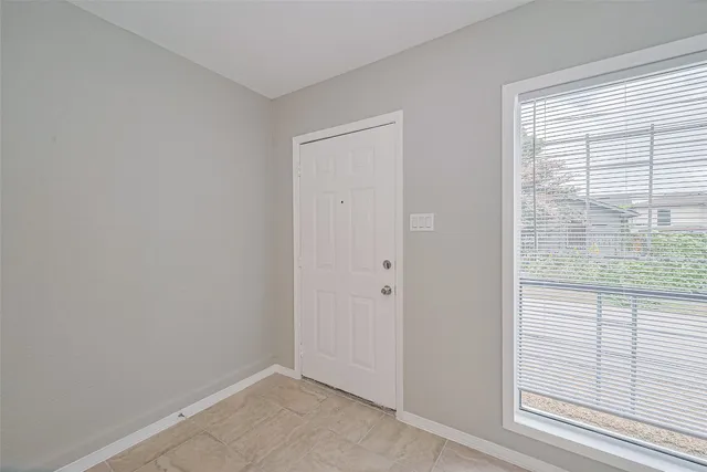 a view of an empty room with a window