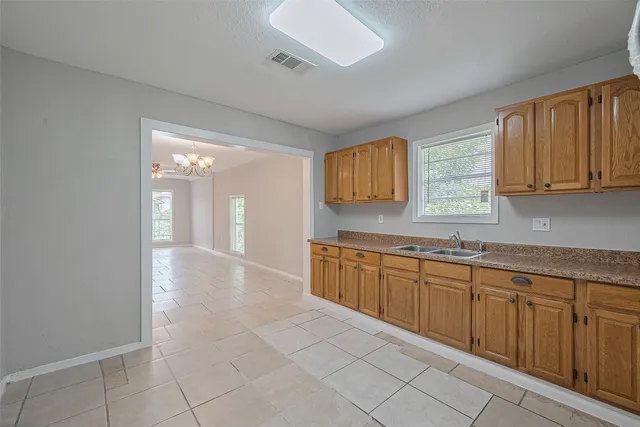 a view of a kitchen with a sink and cabinets