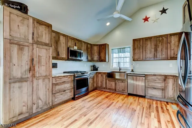 a kitchen with granite countertop stainless steel appliances and wooden cabinets