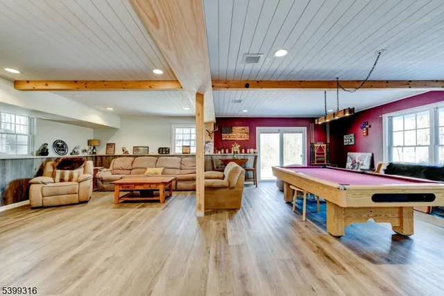 a living room with furniture a wooden floor and a chandelier