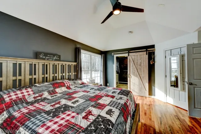 a bedroom with a bed next to a window