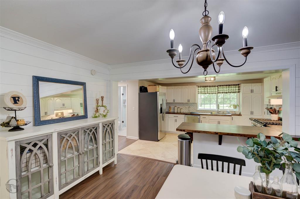 701 Chandler Road Haughton, LA 71037 - Photo 7 of 25 a dining room with wooden floor chandelier wooden table and chairs