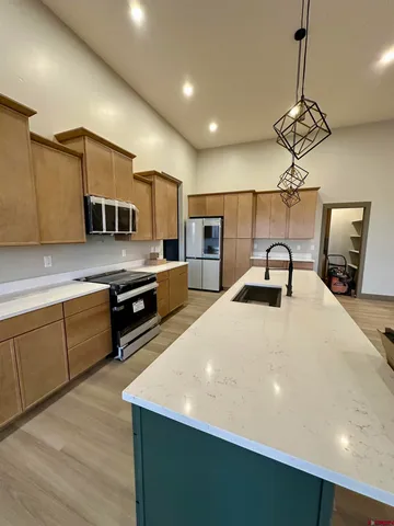a kitchen with a sink and a stove top oven