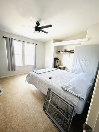 a bedroom with a bed and a large window