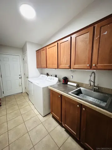a kitchen with a sink stove and cabinets