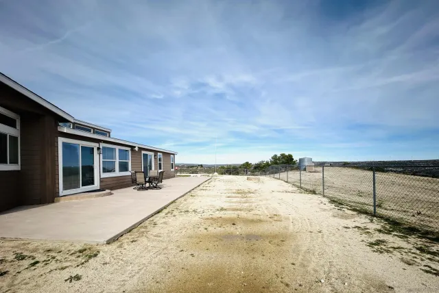 a view of backyard with seating area and barbeque oven