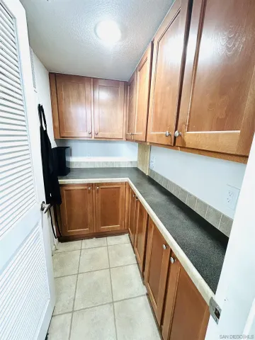a view of a kitchen with kitchen island granite countertop a sink a counter top space and appliances