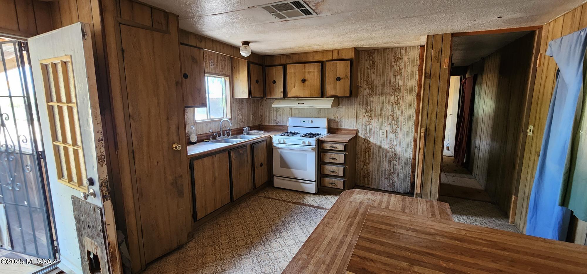 4401 North Musket Road Marana, AZ 85653 - Photo 5 of 15 a kitchen with stainless steel appliances granite countertop a refrigerator and a sink