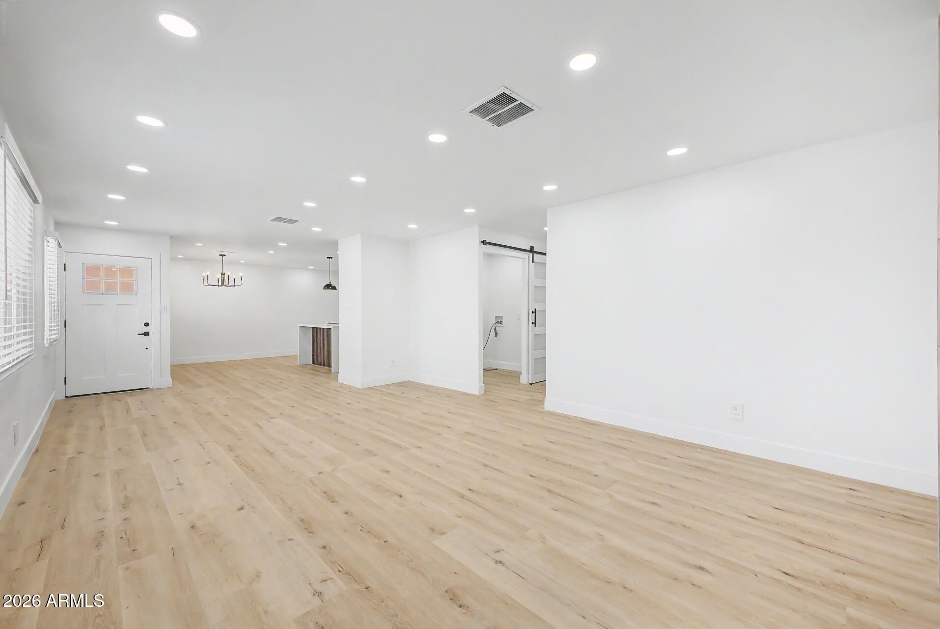 5232 West Hearn Road Glendale, AZ 85306 - Photo 7 of 32 a view of an empty room with wooden floor