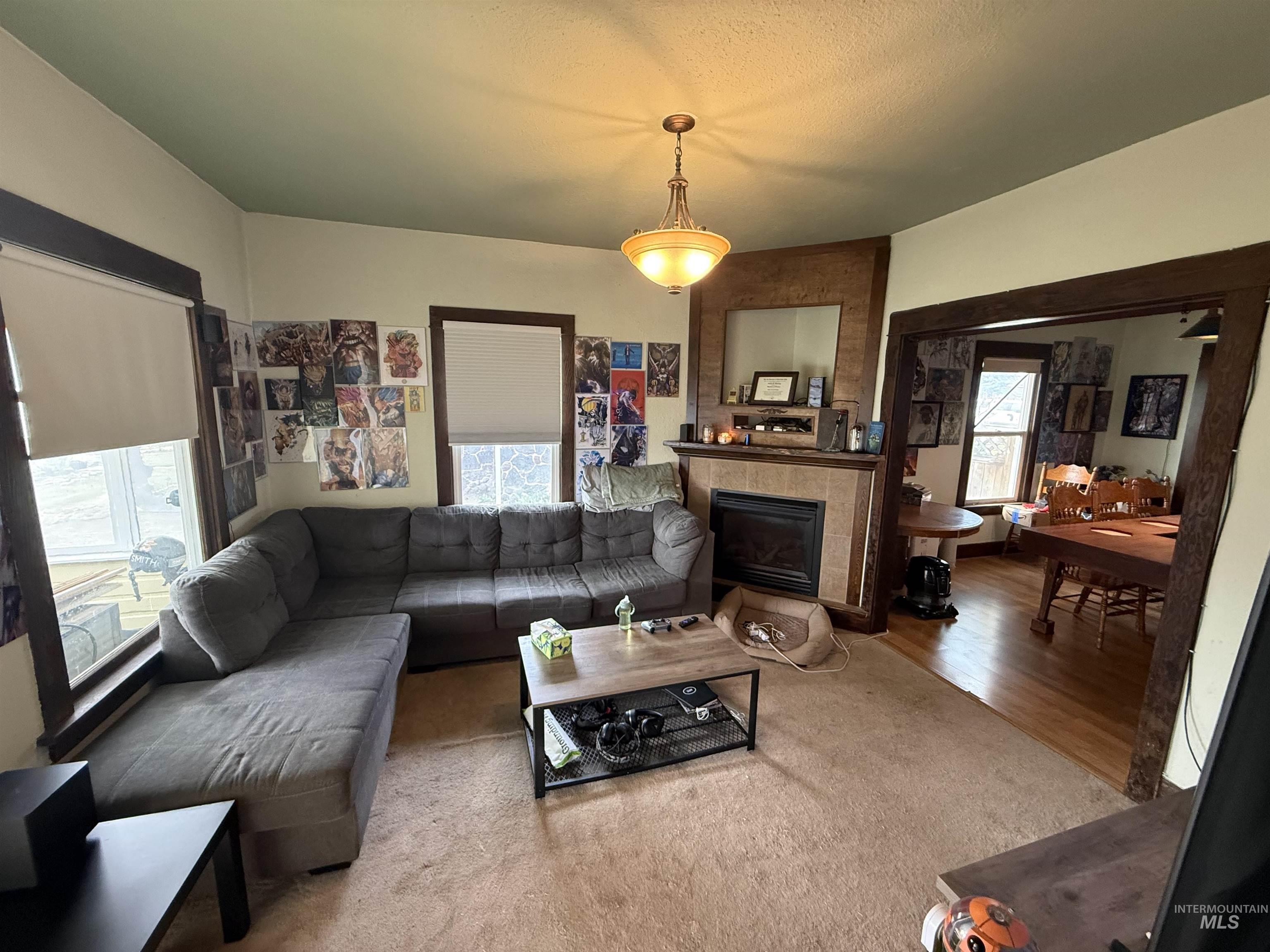 918 5th Street Rupert, ID 83350 - Photo 2 of 14 Living room with a tiled fireplace and a textured ceiling