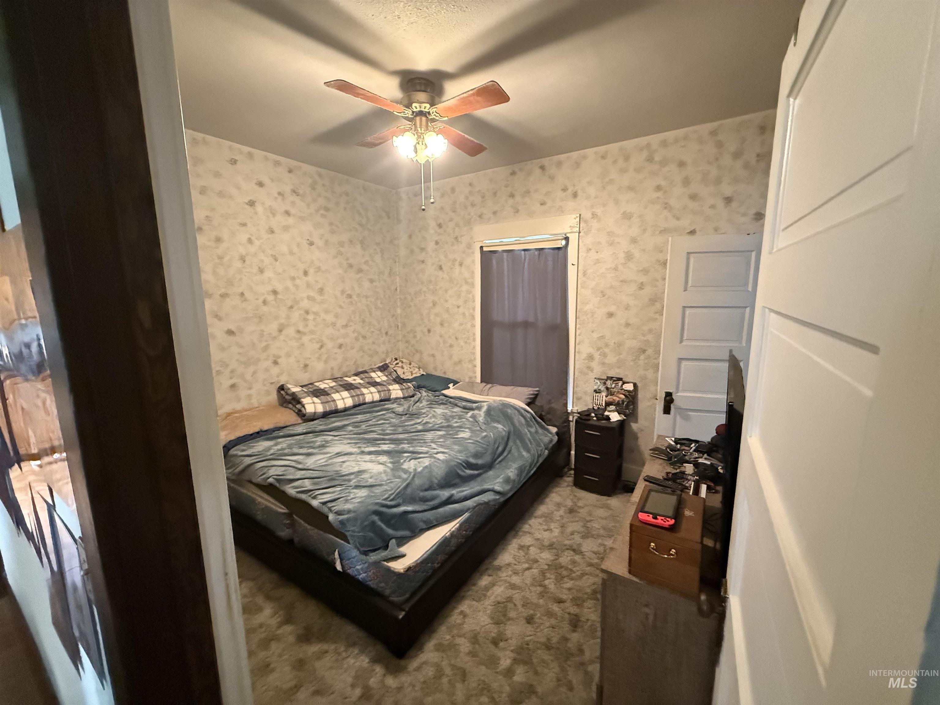 918 5th Street Rupert, ID 83350 - Photo 4 of 14 Bedroom with carpet, wallpapered walls, and ceiling fan