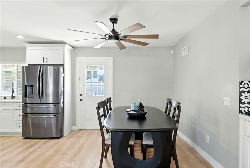 811 West James Street Rialto, CA 92376 - Photo 11 of 43 a kitchen with stainless steel appliances a refrigerator a sink a stove a dining table and chairs