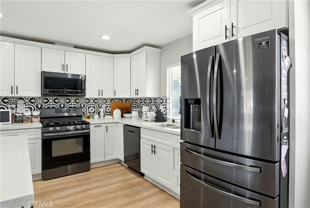 811 West James Street Rialto, CA 92376 - Photo 12 of 43 a kitchen with stainless steel appliances a refrigerator stove and microwave