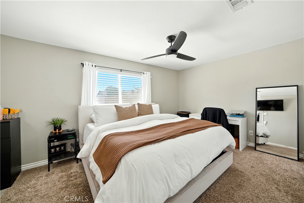811 West James Street Rialto, CA 92376 - Photo 15 of 43 a bedroom with a large bed and a window